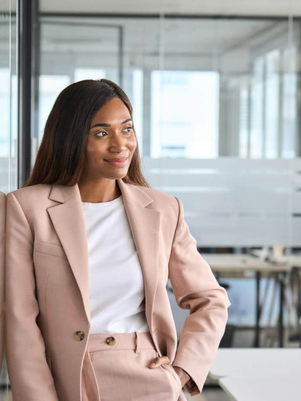 confident-young-business-woman-standing-in-office-looking-away-portrait-.jpg