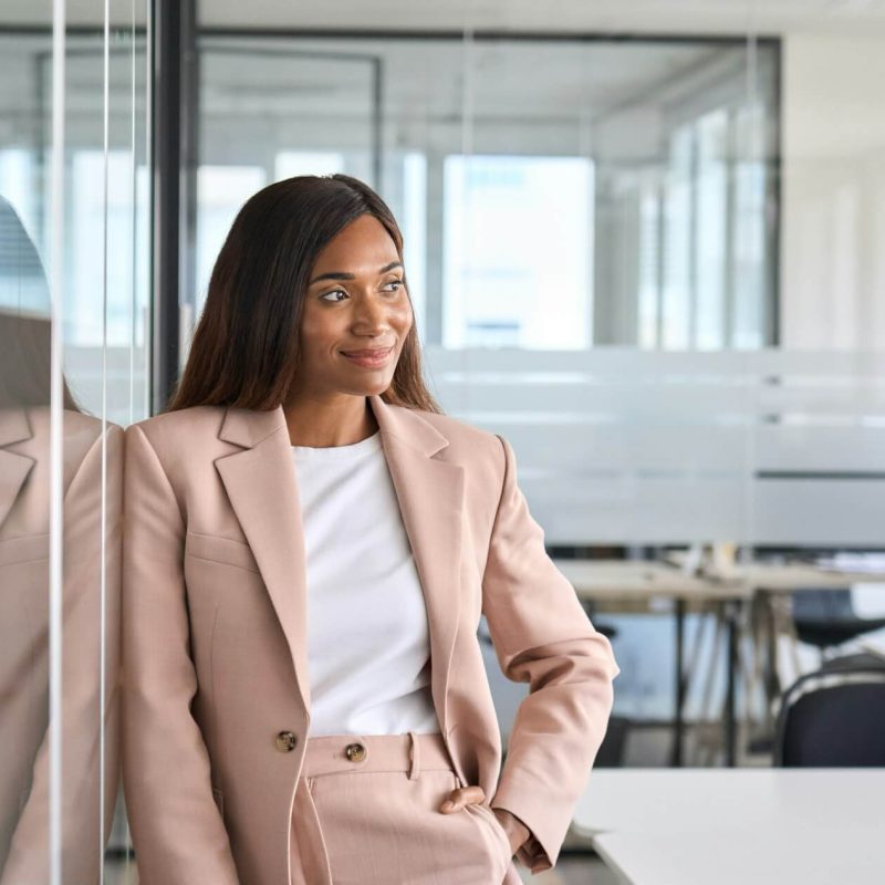 confident-young-business-woman-standing-in-office-looking-away-portrait-.jpg